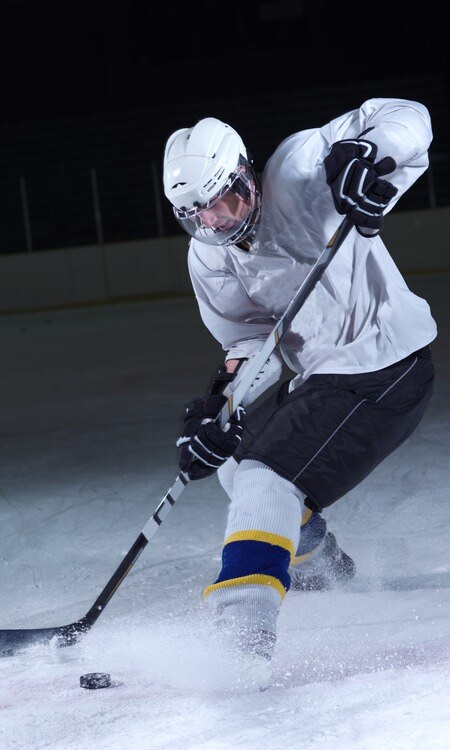 ice hockey player in action kicking with stick-1